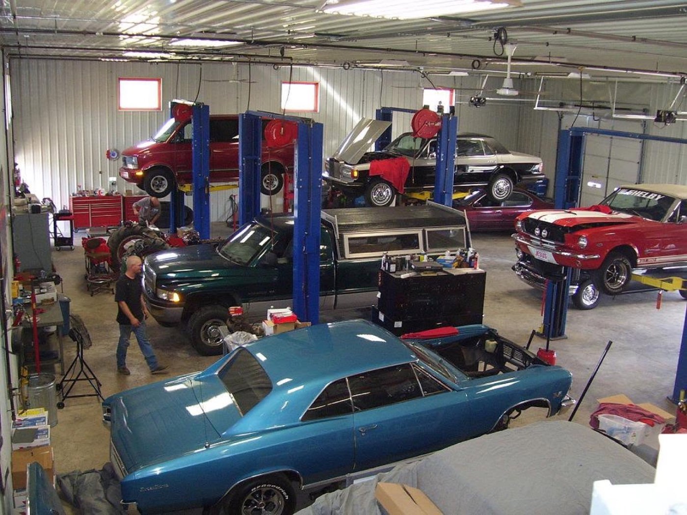 Brady's Auto Service shop floor with multiple vehicles on lifts